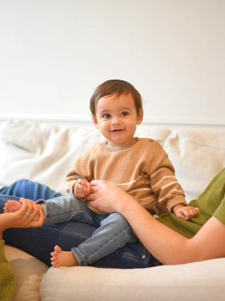 Mum and dad on sofa with baby