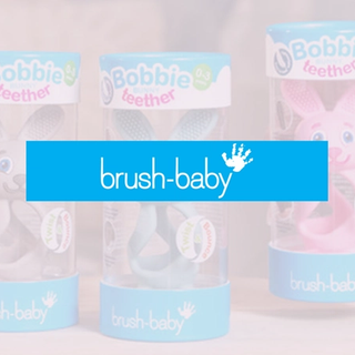 Brush-Baby Bobbie teether toys in colourful packaging with a bold blue Brush-Baby logo banner across the centre