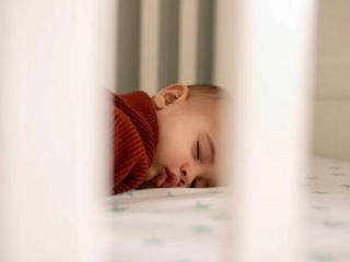 Baby sleeping in cot