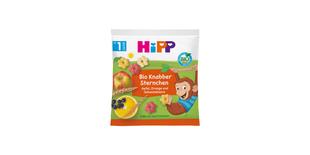 HiPP Bio Knabber Sternchen Snackpackung mit Apfel, Orange, Johannisbeere und spielendem Affenmotiv auf grün-oranger Vorderseite