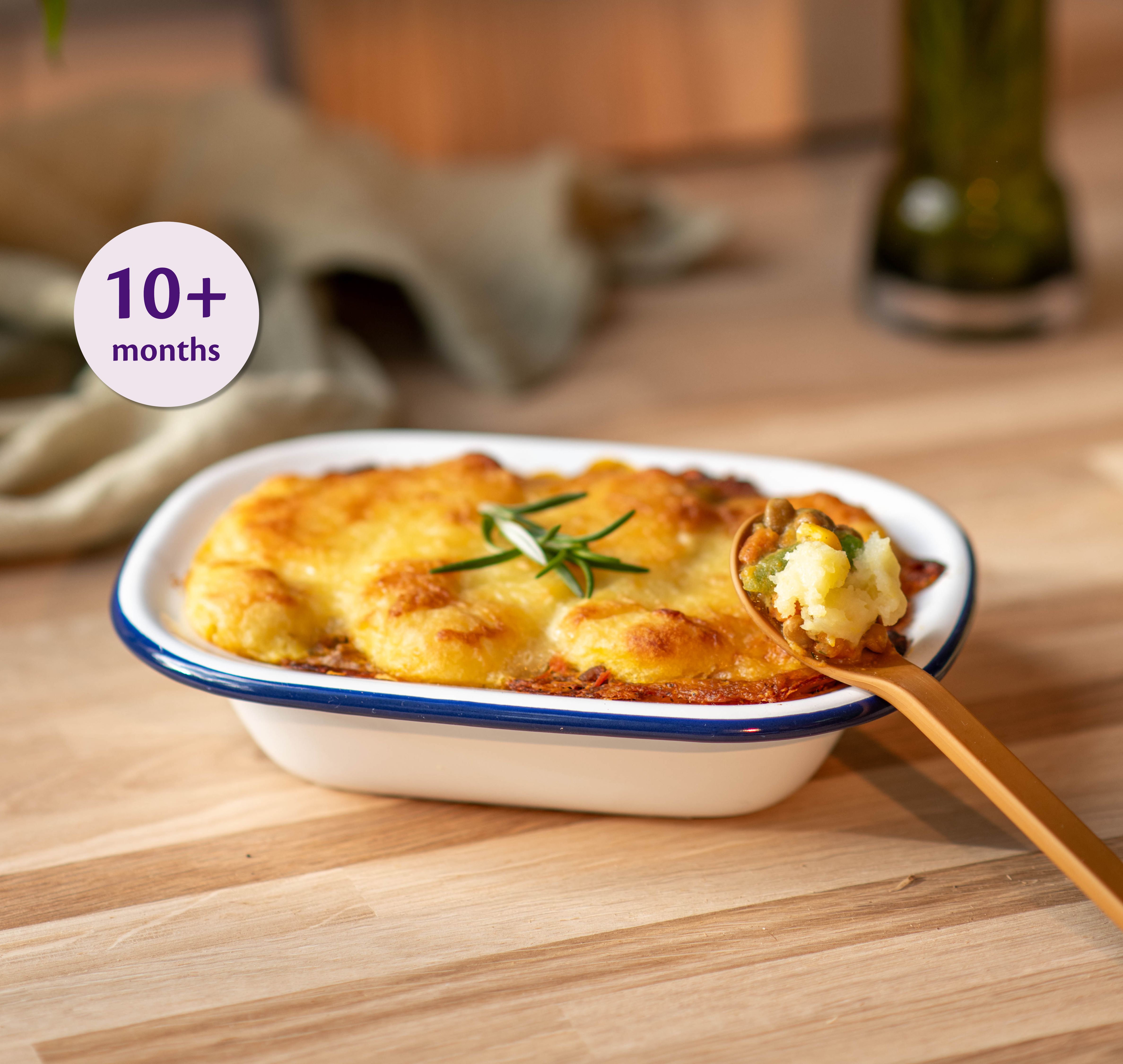 Mini Chicken & Lentil Mash Bake served on a bamboo plate