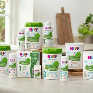 Range of HiPP Organic formula milks, including first infant, follow on, comfort and anti‑reflux, arranged on a bright kitchen worktop