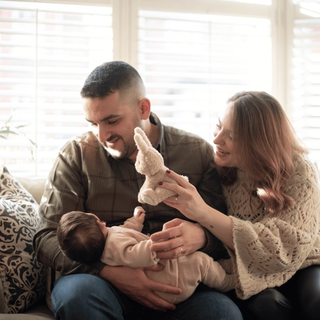 Mum and dad holding their newborn