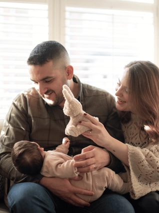 Mum and dad holding their newborn