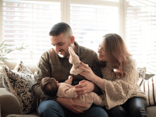 Mum and dad holding their newborn