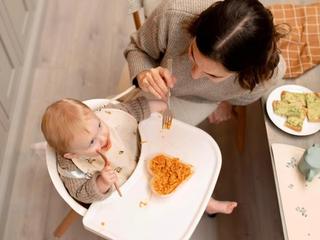 Baby and mum eating at table together