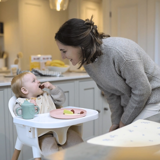 Mum and baby eating fruit