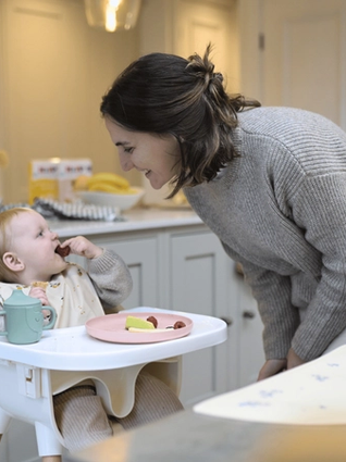 Mum and baby eating fruit