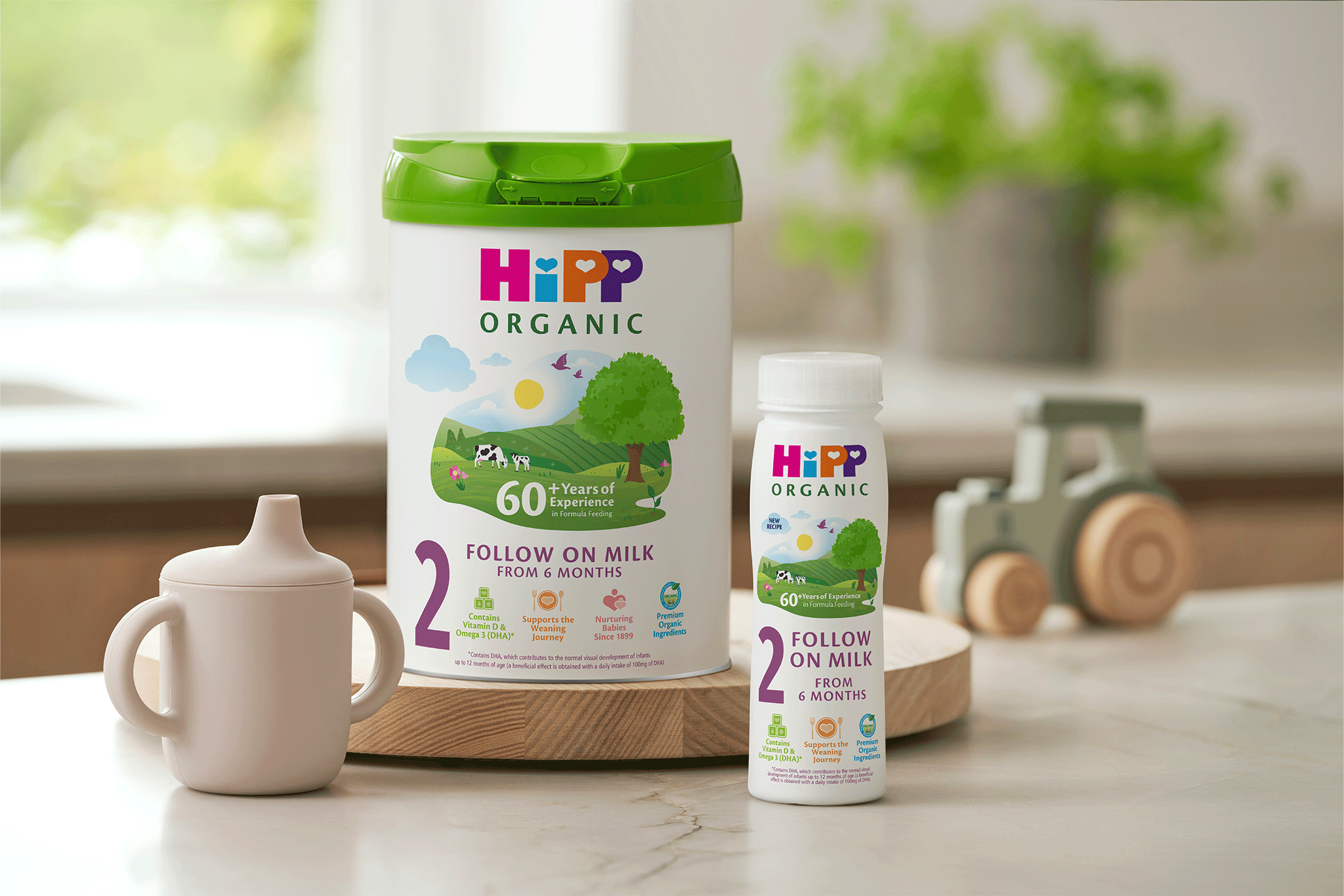 HiPP Organic Follow On Milk Tin and Ready To Feed bottle on kitchen side