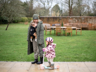 Mum walking with baby and toddler