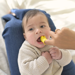 Mum brushing babies teeth