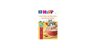 HiPP Guten Morgen Bio Früchte-Müesli Packung mit roter Müslischale, Obststücken und fröhlichem Waschbär-Maskottchen