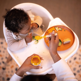 Baby eating at highchair