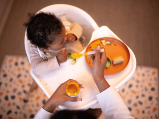 Baby eating at highchair
