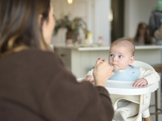 Mum spoon feeding baby