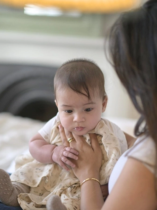 Mum winding baby