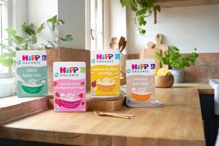 HiPP Organic's collection of cereals on a wooden worktop in a kitchen with green plants