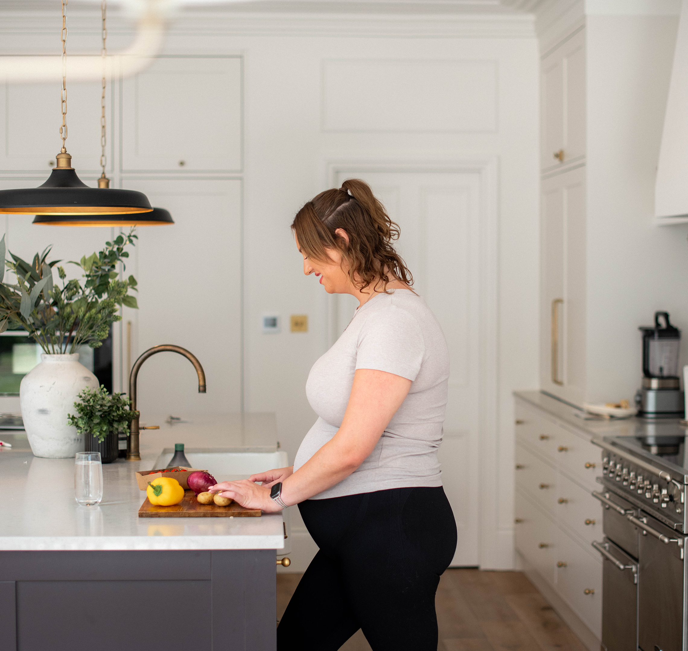 Pregnancy mum chopping vegetables in kitchen