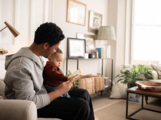 Dad reading to baby