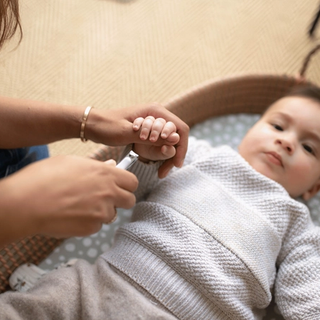 Mum trimming baby's nails
