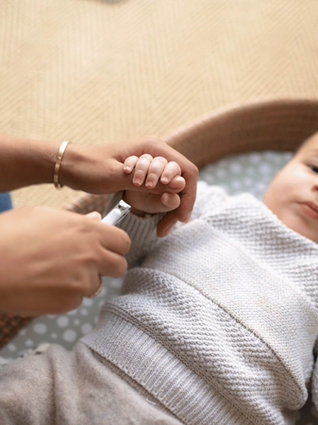 Mum trimming baby's nails