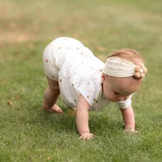 Baby crawling in grass