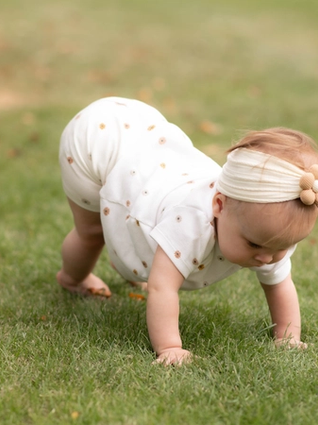Baby crawling in grass