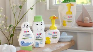 HiPP baby care products on a shelf in a bath by window