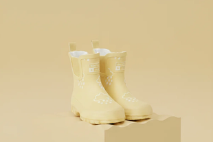 Pair of pale yellow Grass & Air children’s wellies with cloud and raindrop print on a matching beige background