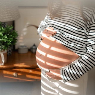 Expecting mum holding bump