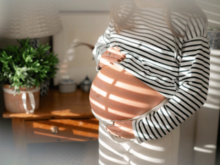 Expecting mum holding bump