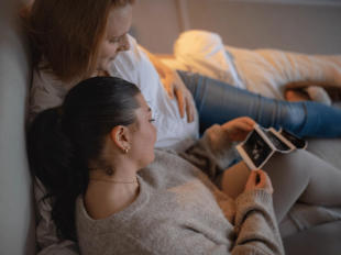 Expecting couple looking at ultrasound scan