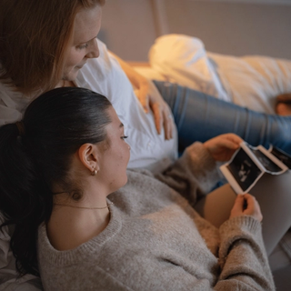 Expecting couple looking at ultrasound scan
