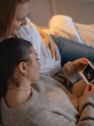 Expecting couple looking at ultrasound scan