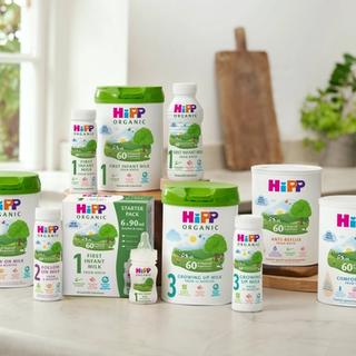 Range of HiPP Organic formula milks, including first infant, follow on, comfort and anti‑reflux, arranged on a bright kitchen worktop