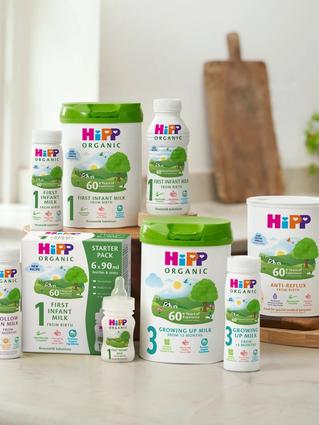 Range of HiPP Organic formula milks, including first infant, follow on, comfort and anti‑reflux, arranged on a bright kitchen worktop