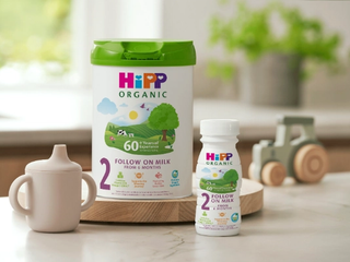 HiPP Organic Follow On Milk Tin and Ready To Feed bottle on kitchen side