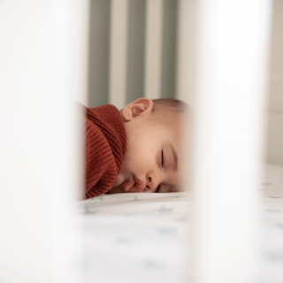 Baby sleeping in cot