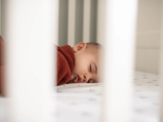 Baby sleeping in cot