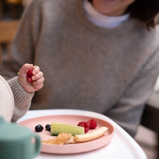 Baby playing with food