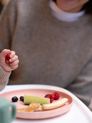 Baby playing with food