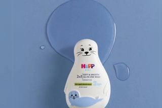 HiPP Soft & smooth all-in-one wash seal on a shelf over a bath next to a bath towel