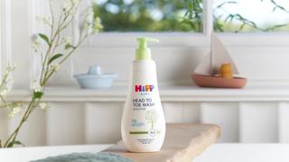 HiPP Baby head to toe wash in a bathroom next to a bath towel
