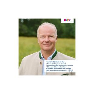 Porträt von Stefan Hipp vor unscharf grünem Hintergrund und Text mit HiPP-Logo