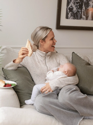 Mum eating lunch whilst holding baby