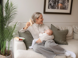 Mum eating lunch whilst holding baby