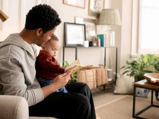 Uncle reading a book with his nephew