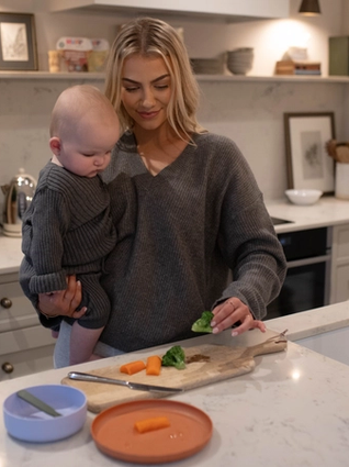 Mum prepping vegetables for baby led weaning