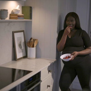 Pregnant woman eating fruit