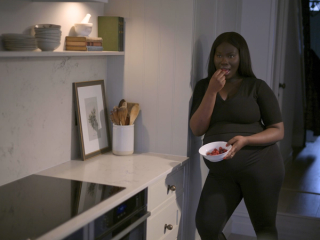Pregnant woman eating fruit